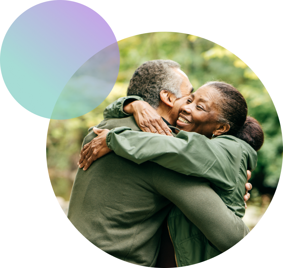 A mature African American couple embraces.